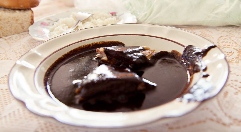 Bowl of mole negro with turkey served with rice