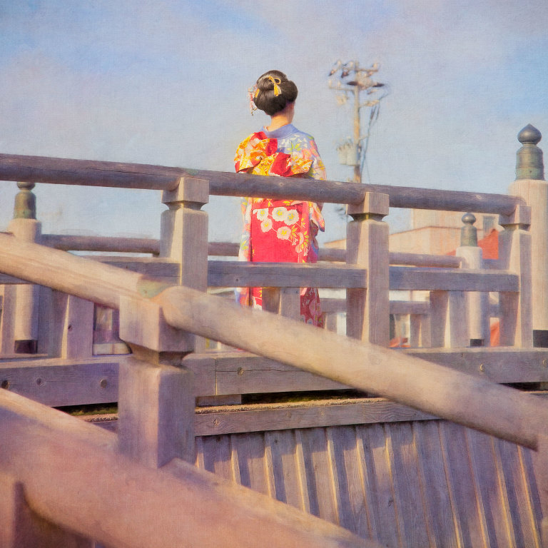 Young woman wearing traditional kimono and hair style on Naka-no Hash Bridge in Kazue Machi Chaya District