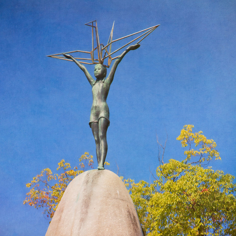 Statue based on the story of Sadako Sasaki with a crane on top of the Children's Peace Monument