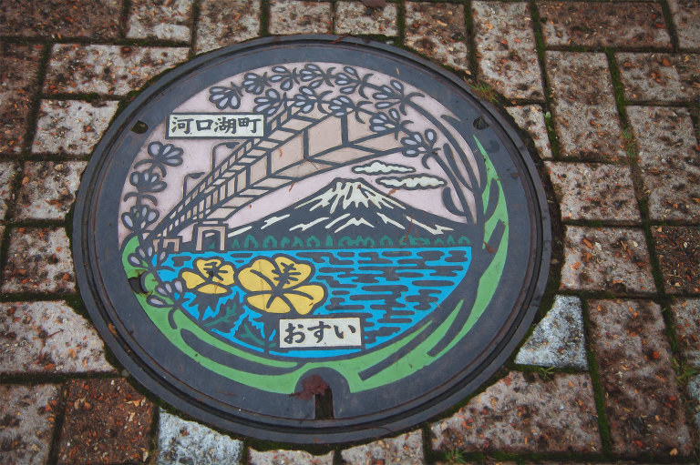 Decorative local maintenance hole cover with Kawaguchiko Ohashi Bridge